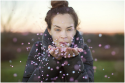 girl blowing confetti, joy, beauty, life coaching